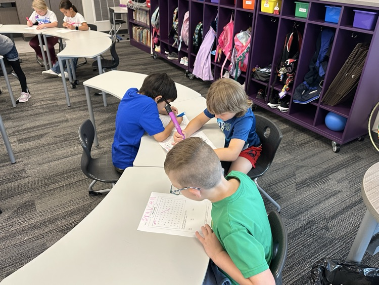 Working with partners to find their spelling words.
