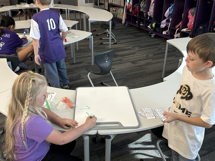 First graders solving real world word problems in math.  