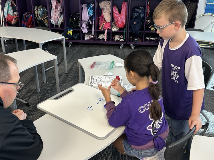 First graders solving real world word problems in math.