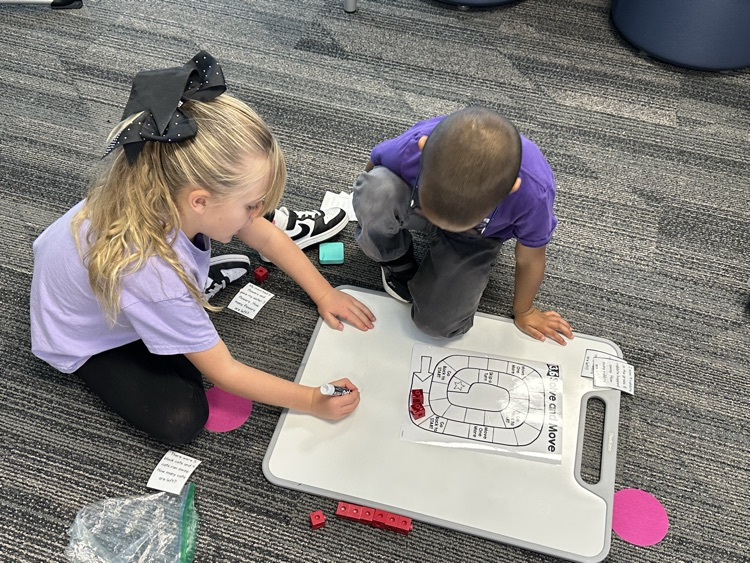 First graders solving real world word problems in math.