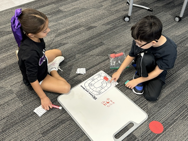 First graders solving real world word problems in math.