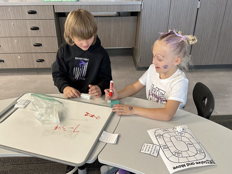 First graders solving real world word problems in math.