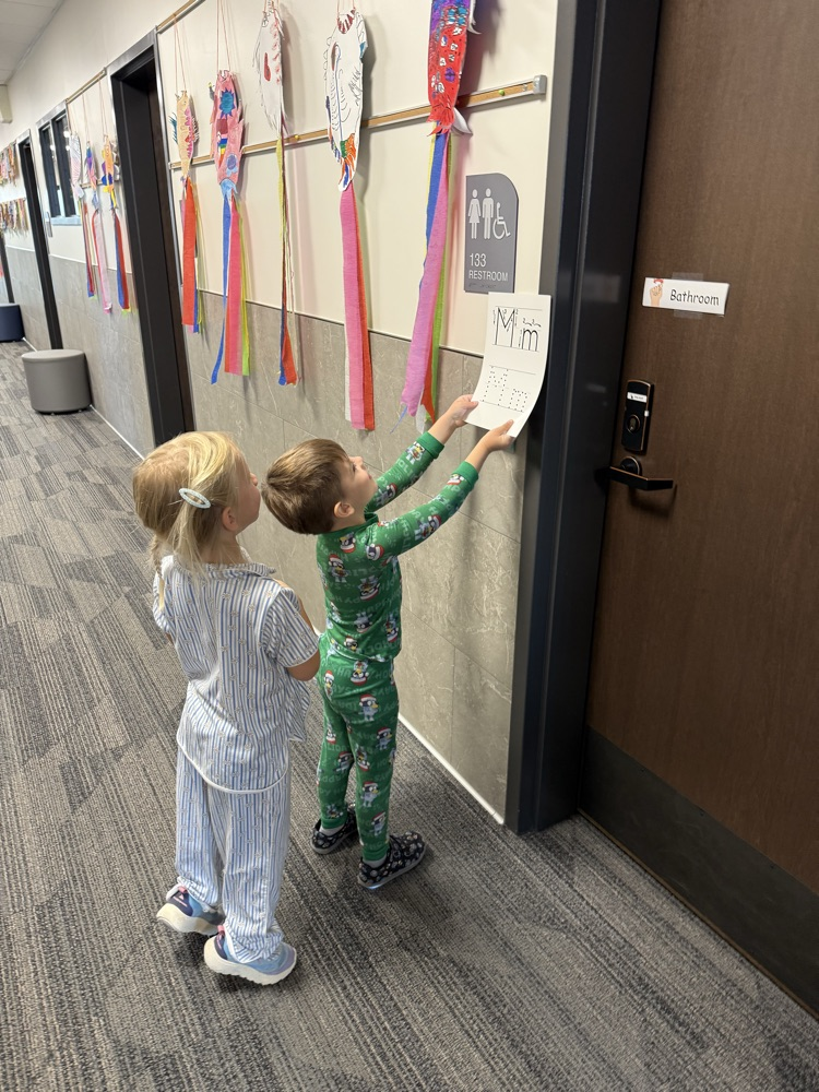 students locating their given letter on signs throughout the school hallways