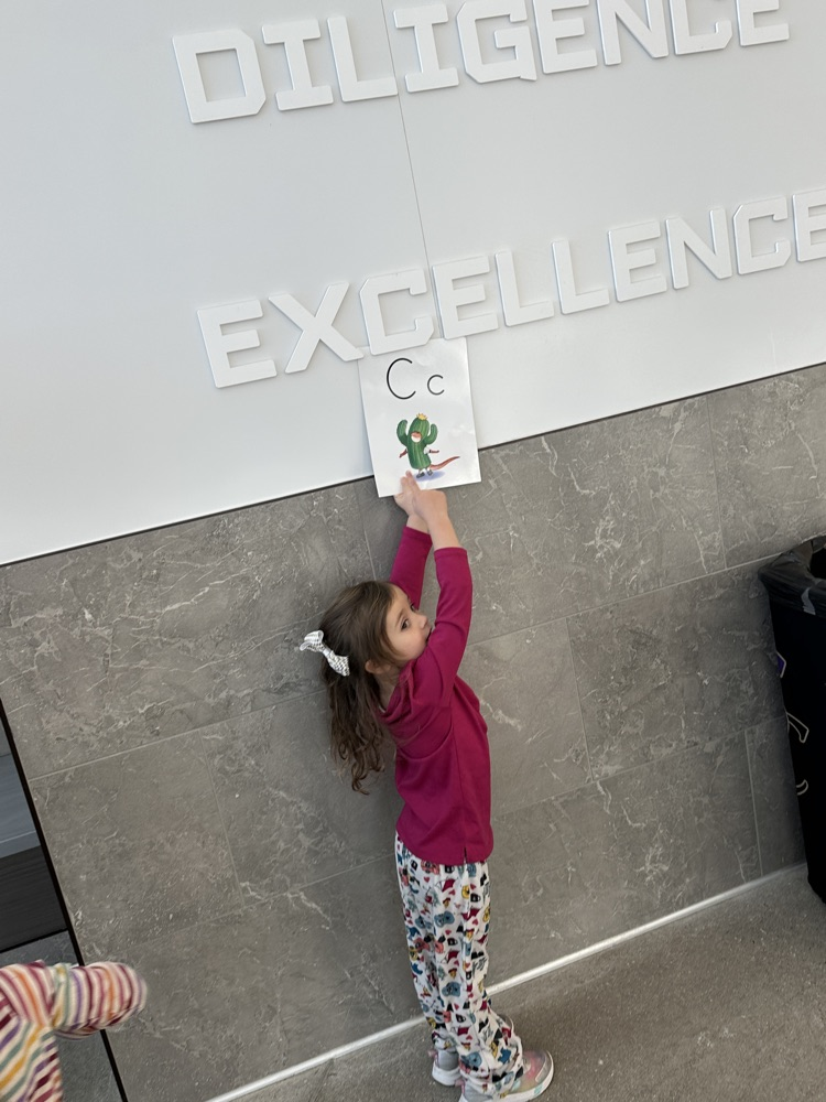 students locating their given letter on signs throughout the school hallways