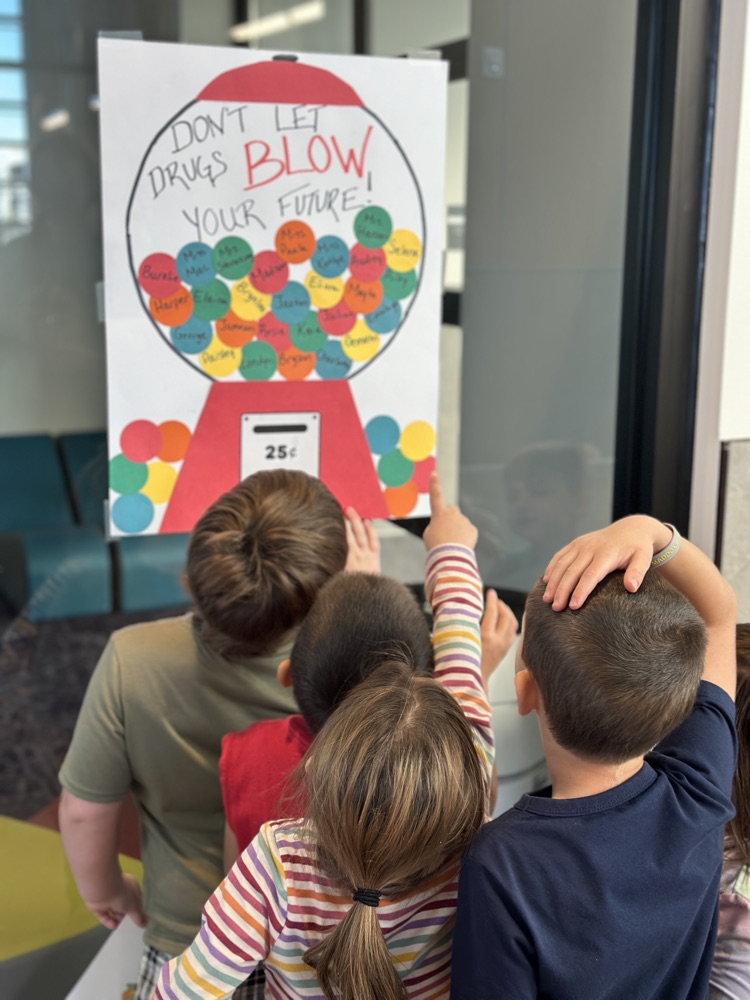 students locating their given letter on signs throughout the school hallways