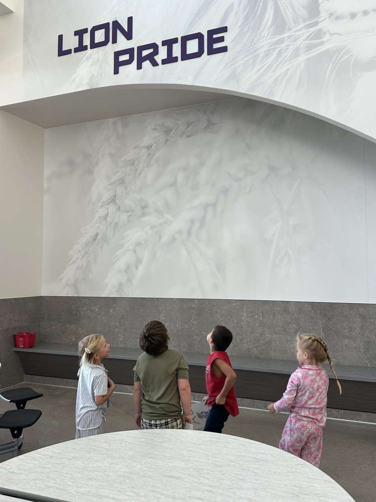 students locating their given letter on signs throughout the school hallways