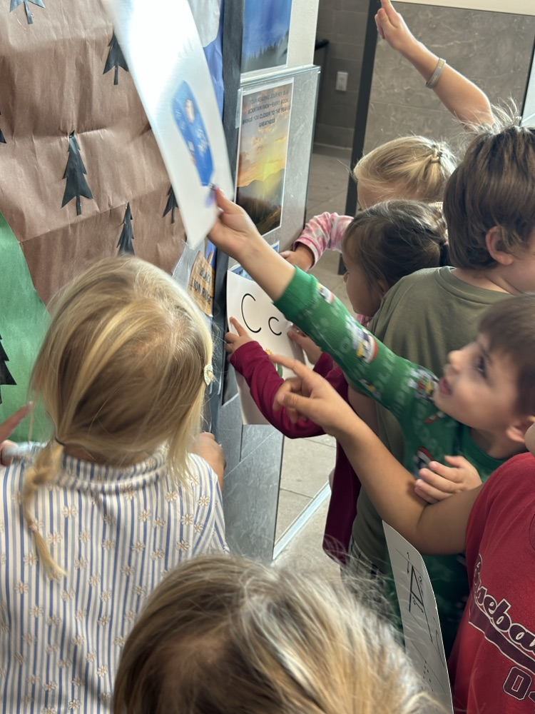 students locating their given letter on signs throughout the school hallways