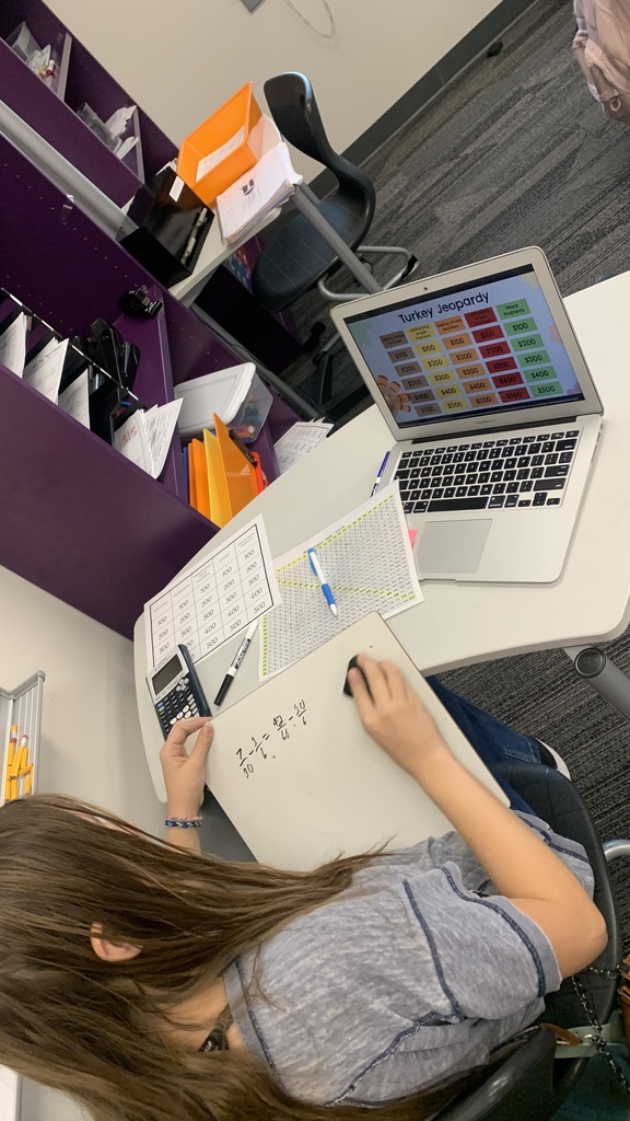 We can see one student up close and we can see their work on a whiteboard