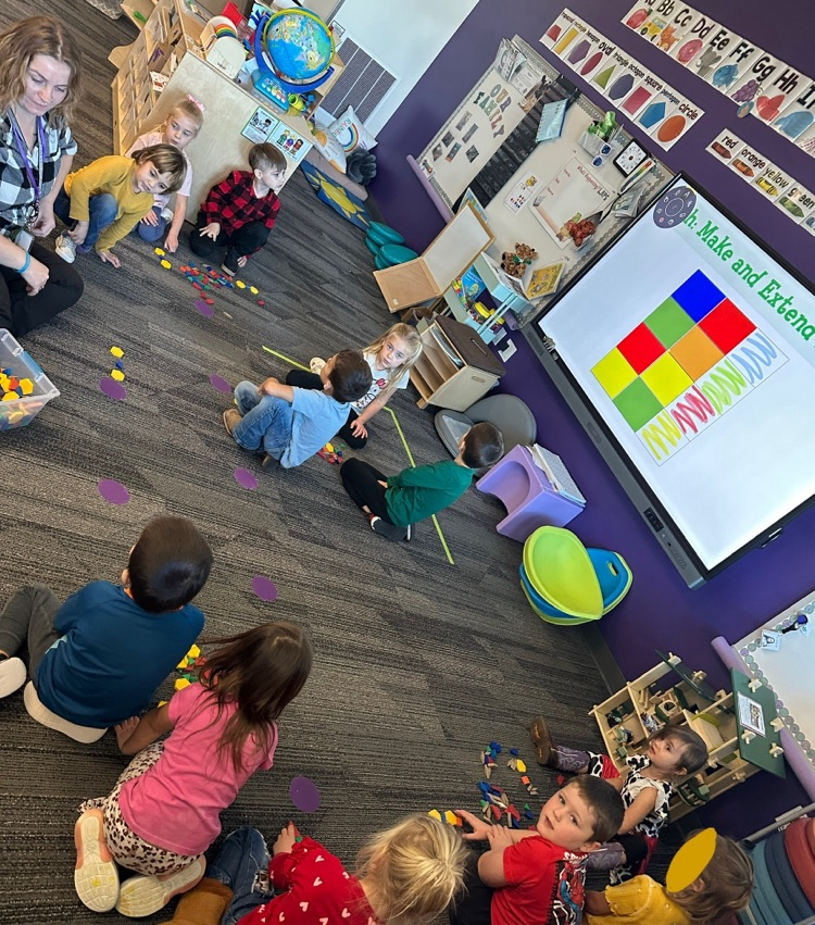 students using pattern blocks to create color patterns 