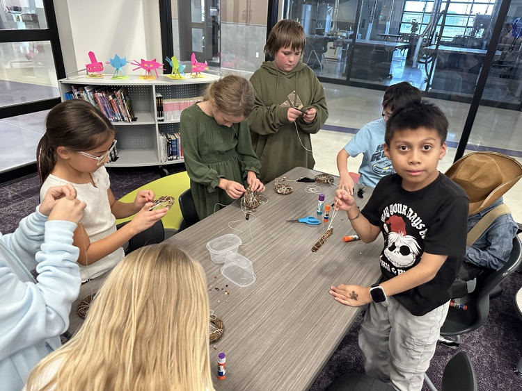 Buddy classes working together to make dream catchers  