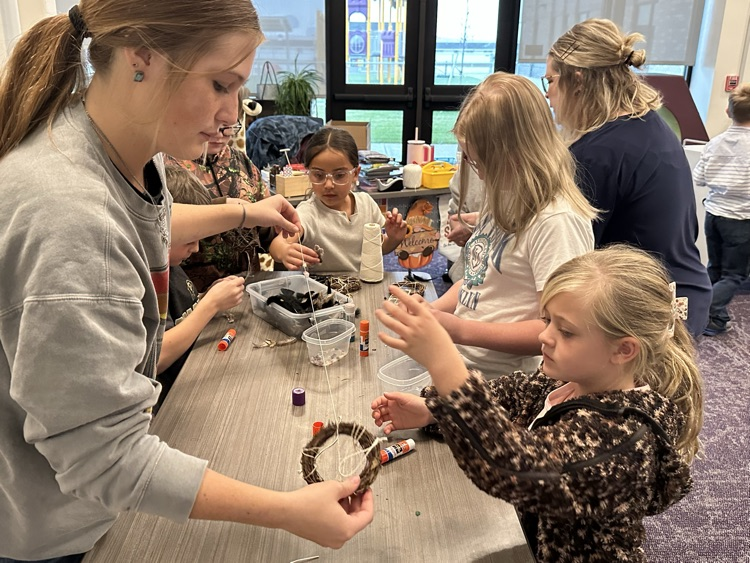 Buddy classes working together to make dream catchers