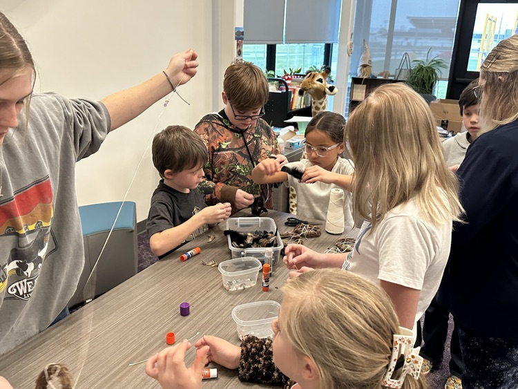 Buddy classes working together to make dream catchers