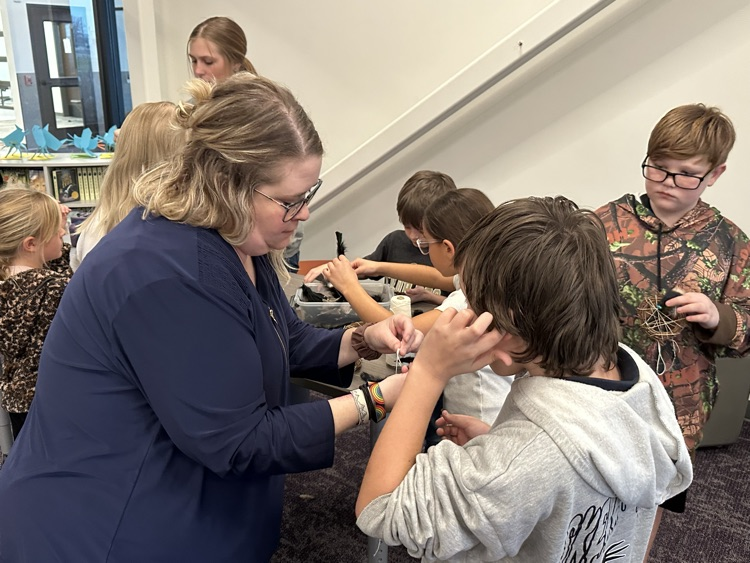 Buddy classes working together to make dream catchers