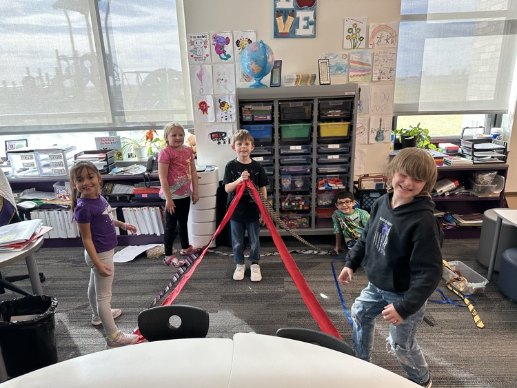 1st graders finishing their unit on Geometry by building 3-D objects with tied and ribbons.