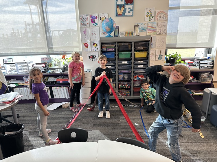 1st graders finishing their unit on Geometry by building 3-D objects with tied and ribbons.