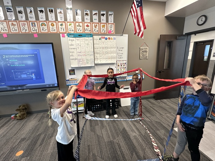 1st graders finishing their unit on Geometry by building 3-D objects with tied and ribbons.