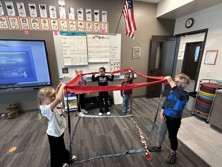 1st graders finishing their unit on Geometry by building 3-D objects with tied and ribbons.