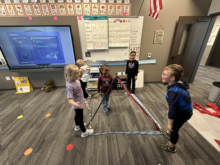 1st graders finishing their unit on Geometry by building 3-D objects with tied and ribbons.