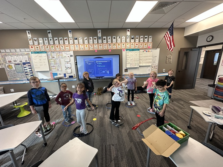 1st graders finishing their unit on Geometry by building 3-D objects with tied and ribbons.