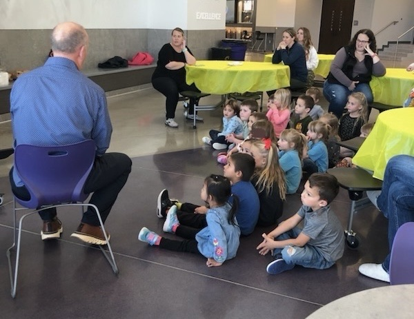 students and families listening to the reading of Charlie Brown Thanksgiving 