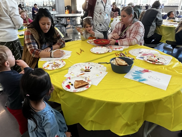 students and families celebrating a Charlie Brown style  Thanksgiving 