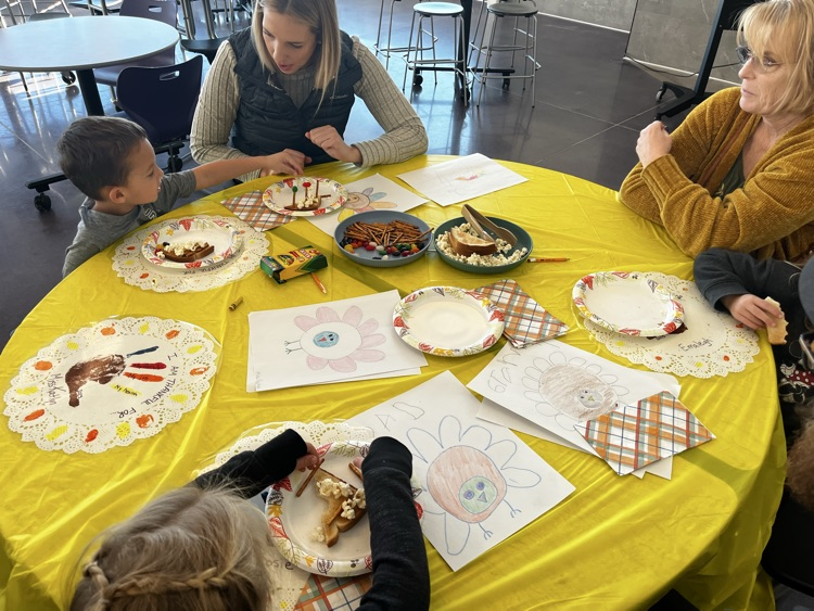 students and families celebrating a Charlie Brown style  Thanksgiving 