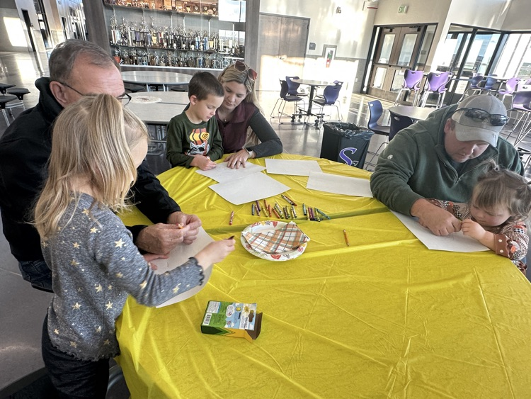 students and families celebrating a Charlie Brown style  Thanksgiving 