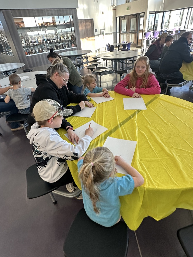 students and families celebrating a Charlie Brown style  Thanksgiving 