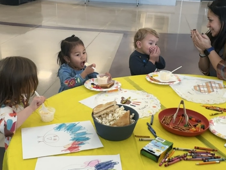 students and families celebrating a Charlie Brown style  Thanksgiving 