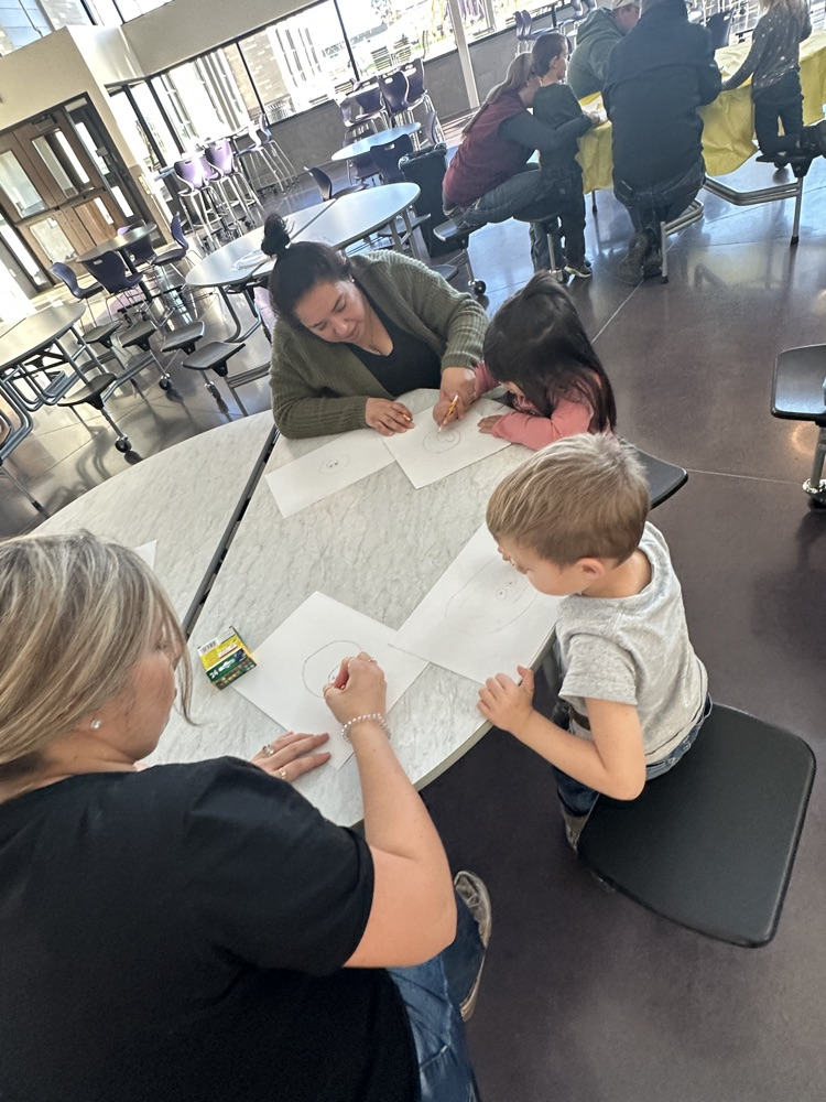 students and families celebrating a Charlie Brown style  Thanksgiving 