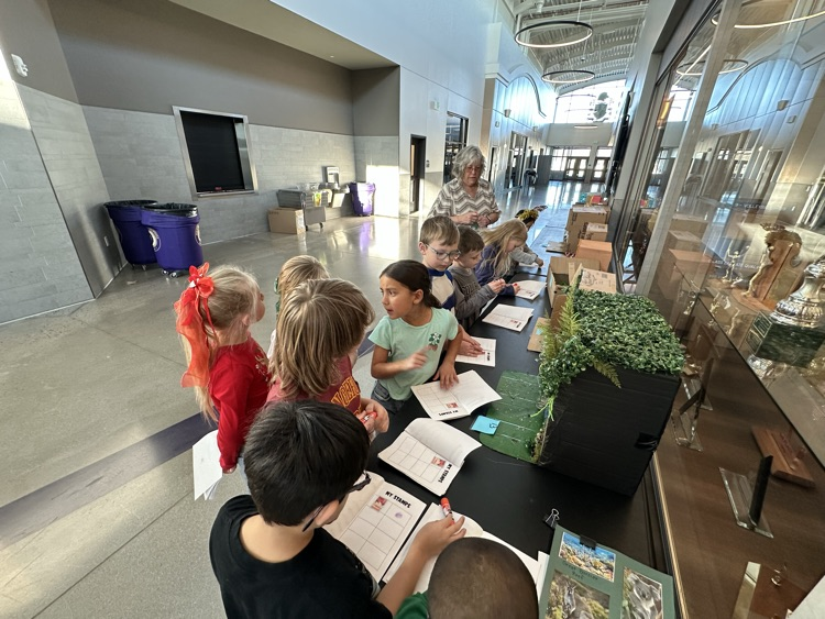 Students collecting another stamp on their passports after telling which Continent they have landed  