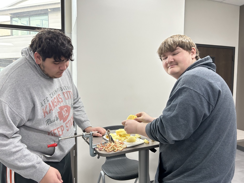 Students slice and peal the apples.