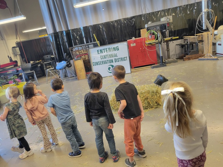 children walking through activity setup in ag room