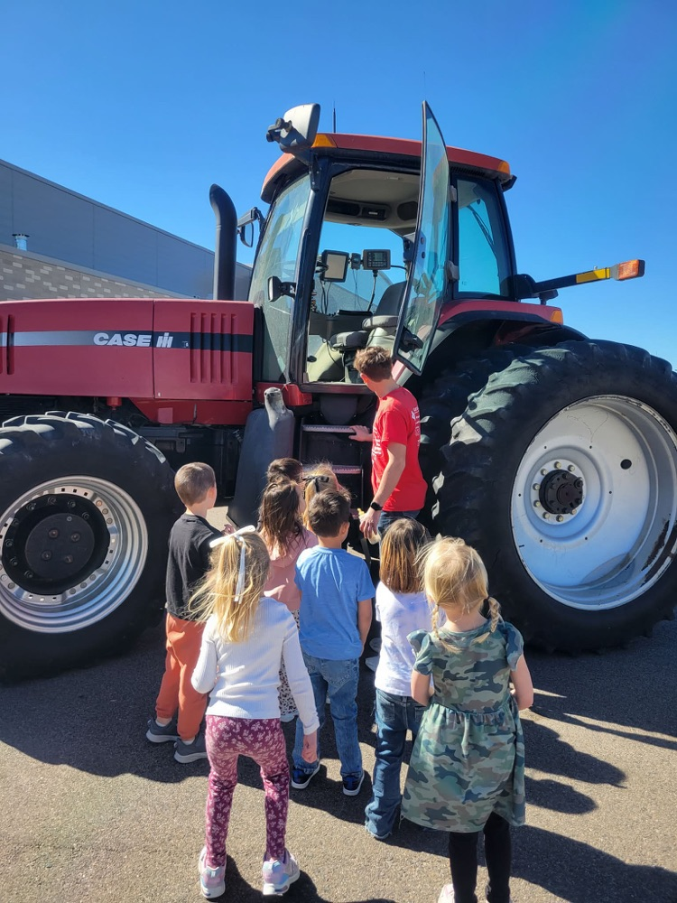 children looking at tractor 