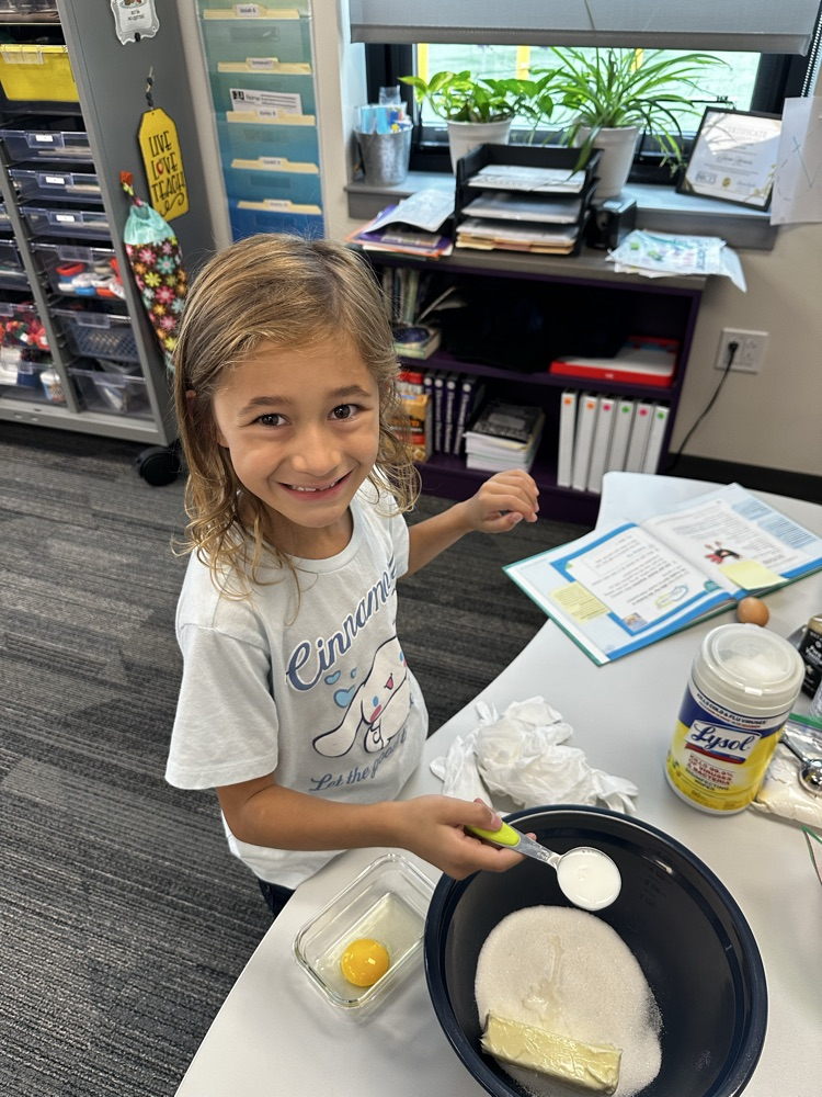 Adding ingredients to make cookies.