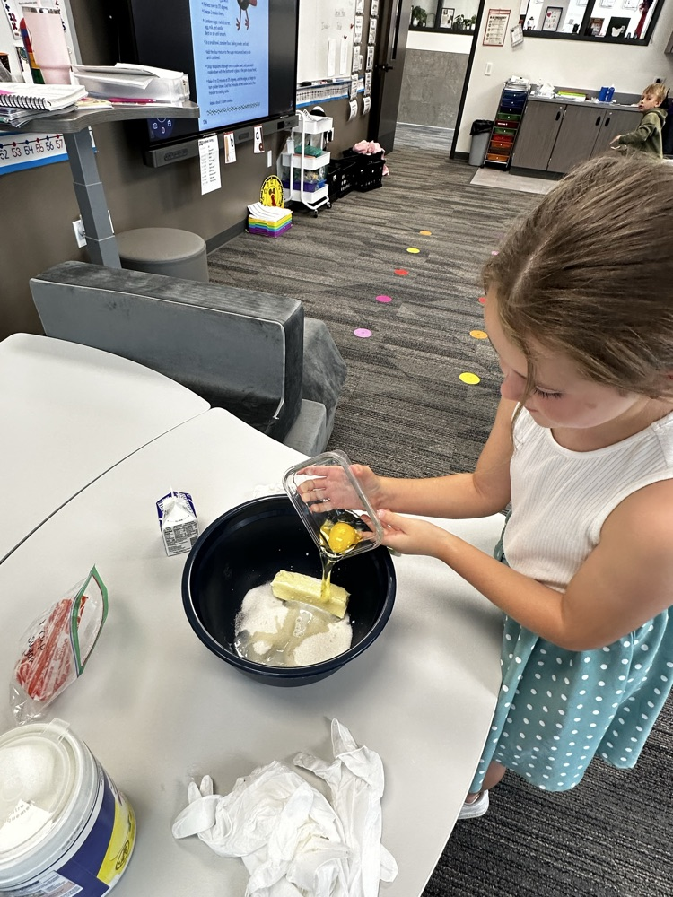 Adding ingredients to make cookies.
