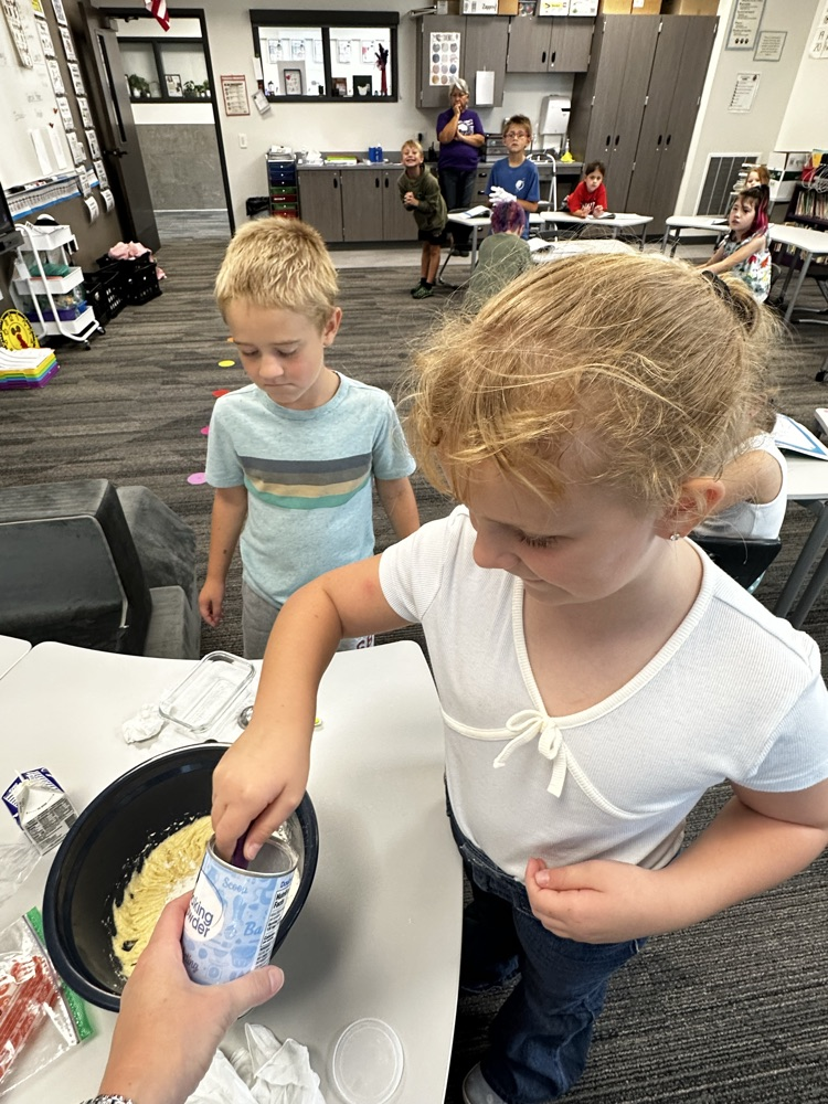 Adding ingredients to make cookies.