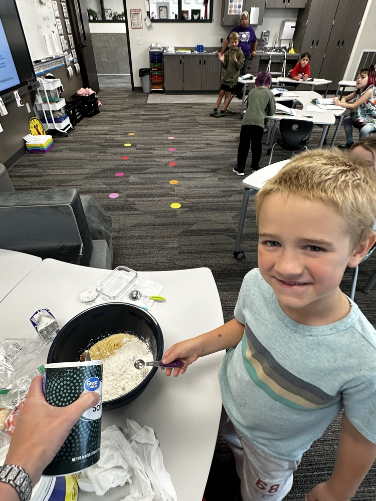 Adding ingredients to make cookies.