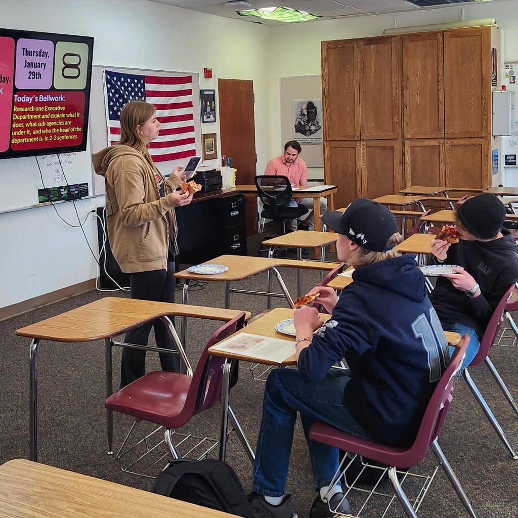 FCA Club president speaks to a small group of students during a lunchtime meeting.
