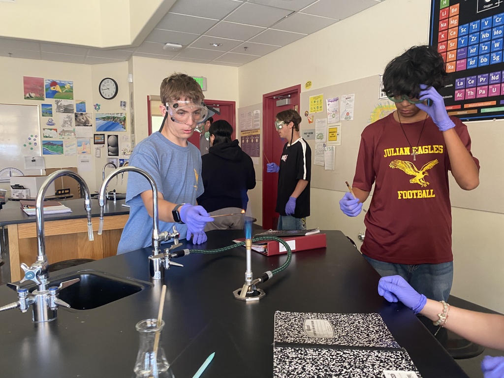 Two chemistry students do an experiment with a bunsen burner.