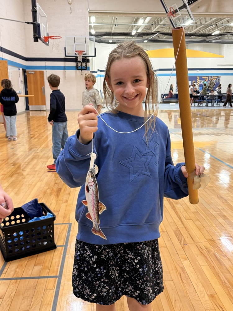 student holding a fish