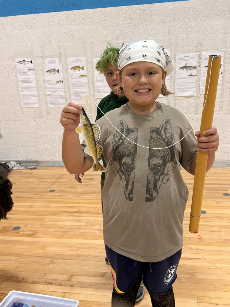 student holding a fish