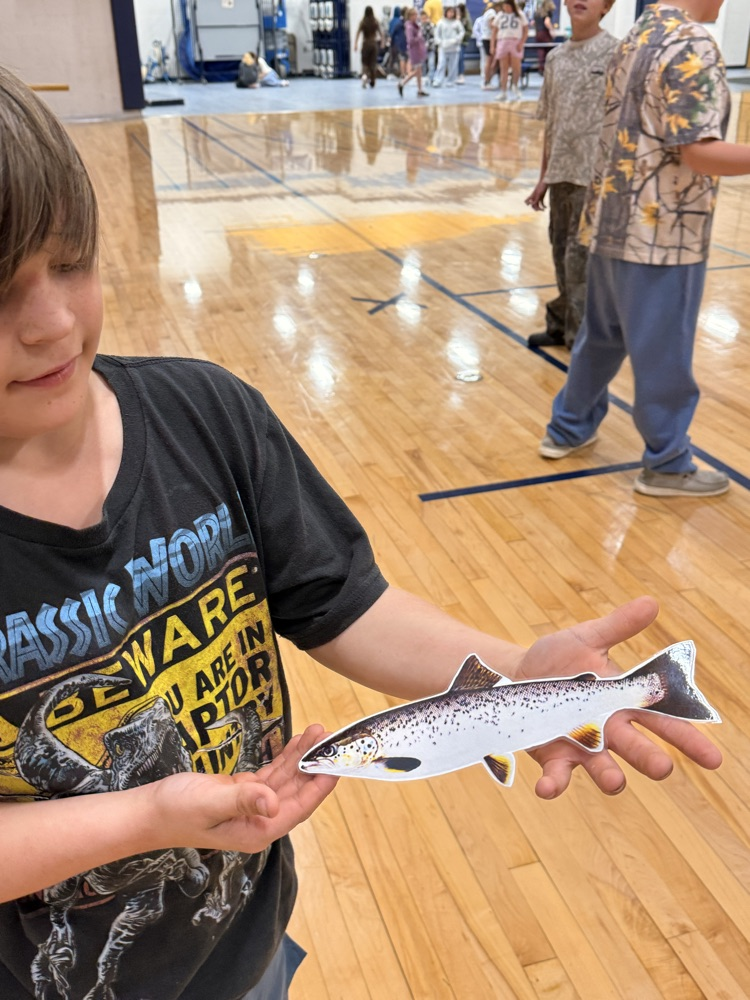 student holding a fish
