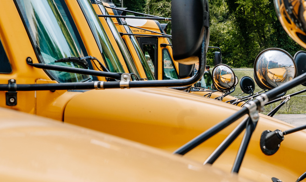 Close up shot of school buses parking at the bus garage.