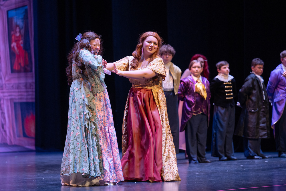 Two high school students on a stage during a play