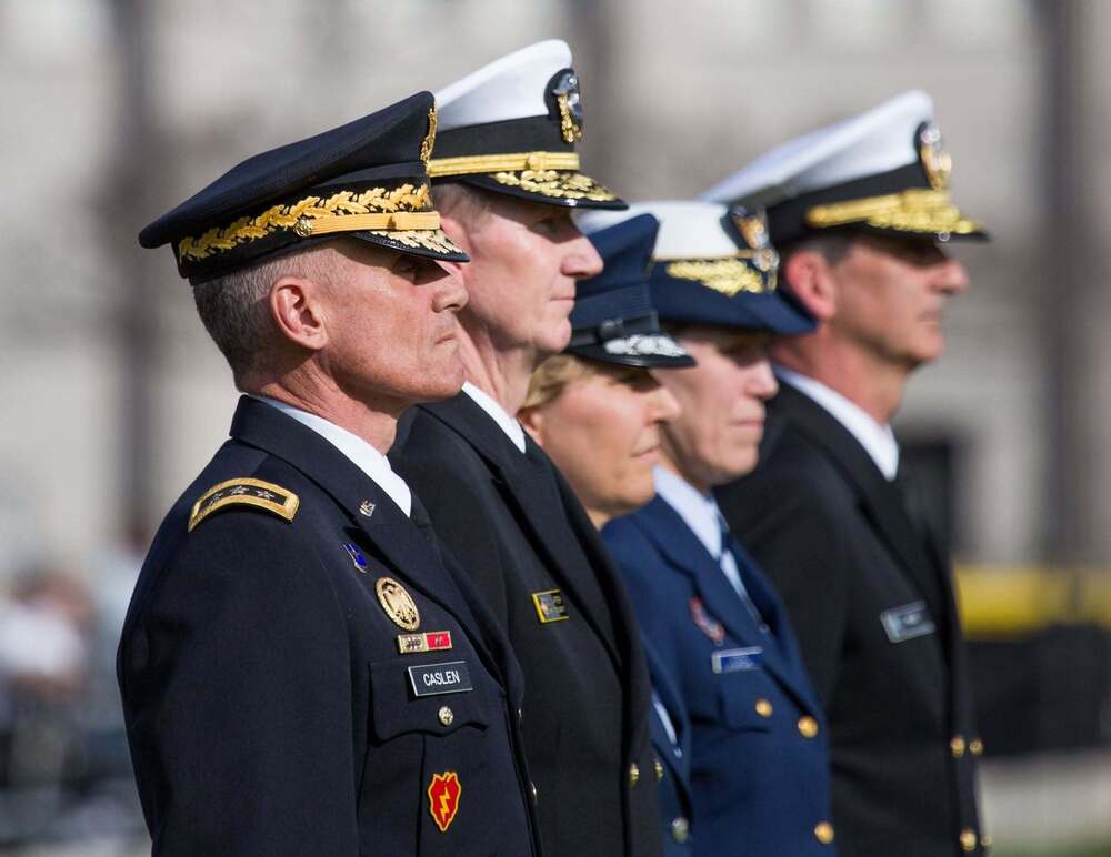 Five military officers wearing their dress uniforms, standing at attention.