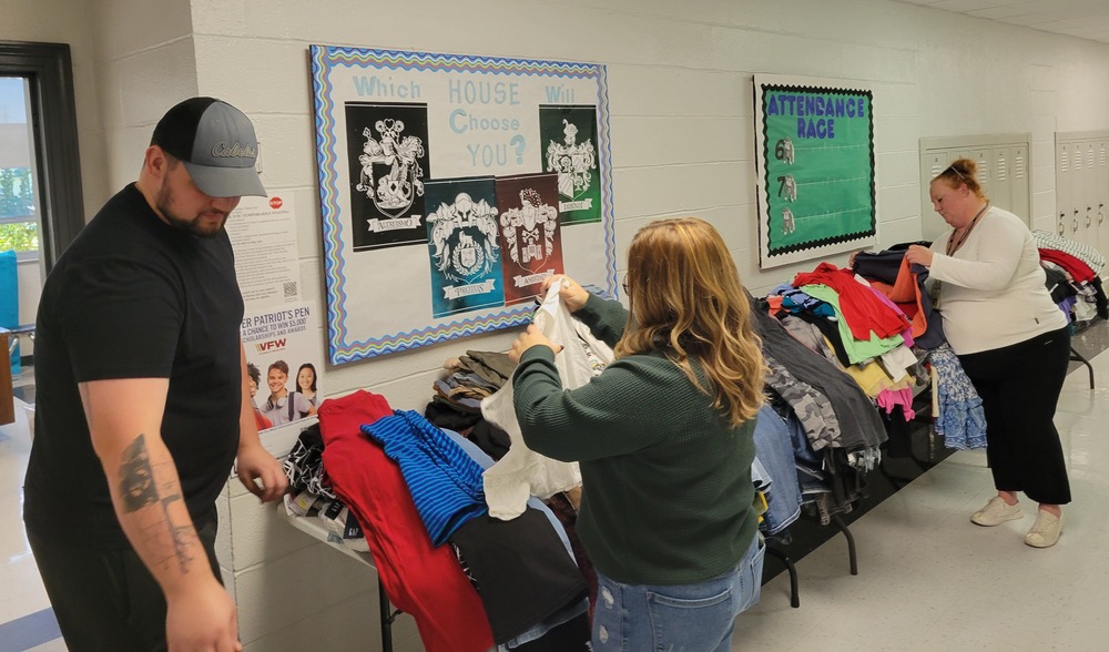 Staff helping sort clothing donations