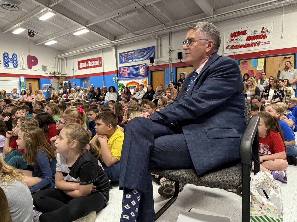 dr. tom williams watching students read their presentations during the event