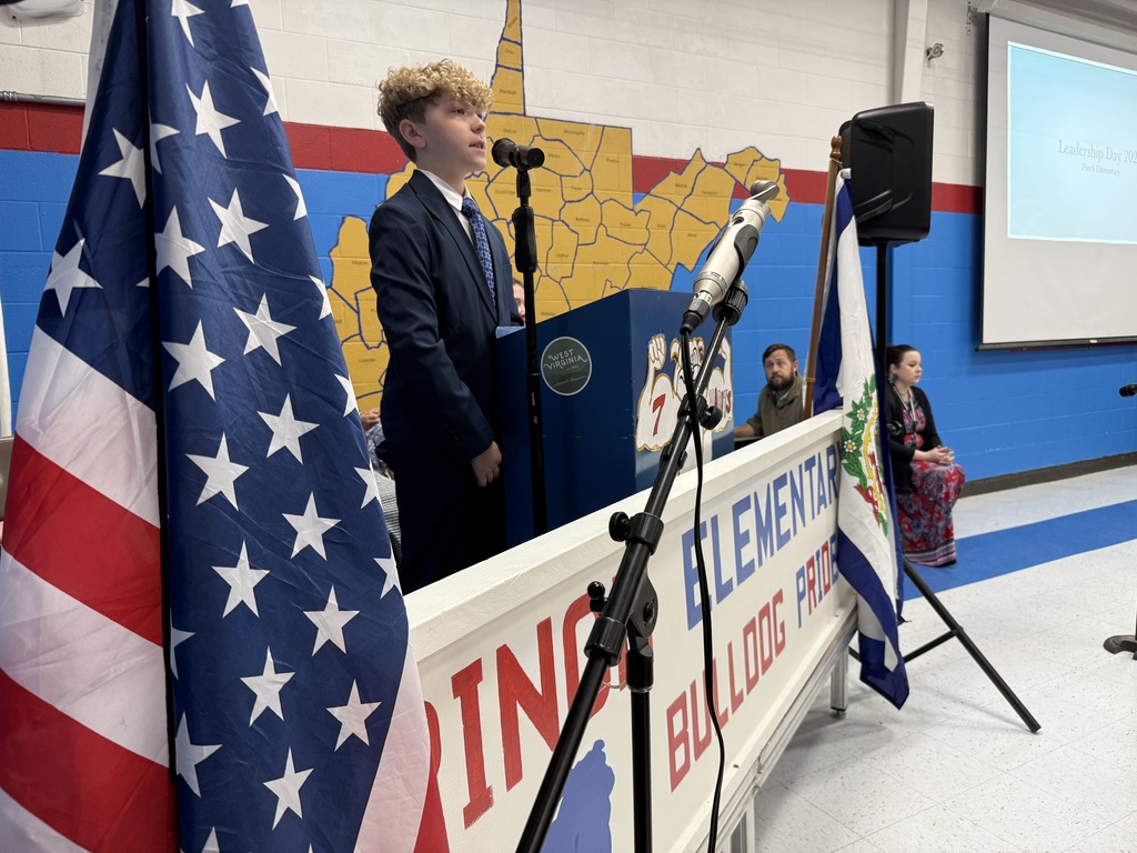 pinch elementary student at the podium welcoming students and guests to leadership day