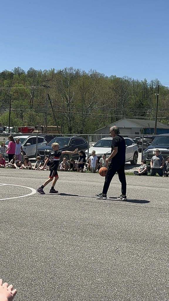 student guarding a staff member as he gets ready to shoot the ball. 